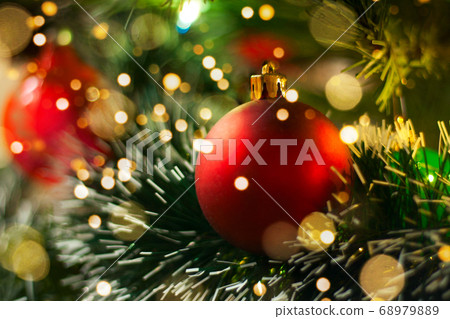 Red Christmas ball with blurred lights. Christmas Decoration. Christmas and Happy New Year card. Red Christmas ball closeup.  68979889