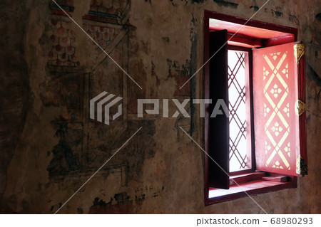 :Detail image of ancient vindow and mural painting is located in Wat Phumin 68980293