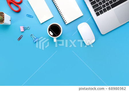 top view blue pastel office desk with computer, office supplies, cell phone, and black coffee cup top view blue pastel office desk with computer, office supplies, cell phone, and black coffee cup 68980362