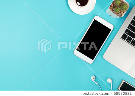 business desk top view with computer, smart phone, coffee cup, ear phone and cactus 68980821