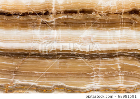 Beige patterned onyx close-up, natural stone backgorund. Beige patterned onyx close-up, natural stone backgorund. 68981591