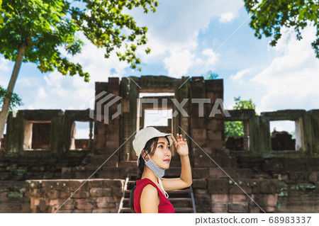 A young tourist is visiting the ancient stone A young tourist is visiting the ancient stone 68983337