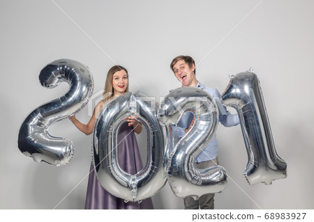 Party, people and new year holidays concept - woman and man celebrating new years eve 2021 Party, people and new year holidays concept - woman and man celebrating new years eve 2021 68983927