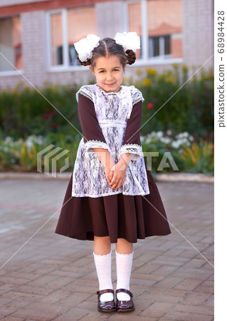 little girl on the street in the form of the USSR with a briefcase, girl in the form of September 1, Soviet uniform little girl on the street in the form of the USSR with a briefcase, girl in the form of September 1, Soviet uniform 68984428