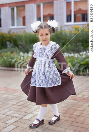 little girl on the street in the form of the USSR with a briefcase, girl in the form of September 1, Soviet uniform little girl on the street in the form of the USSR with a briefcase, girl in the form of September 1, Soviet uniform 68984429