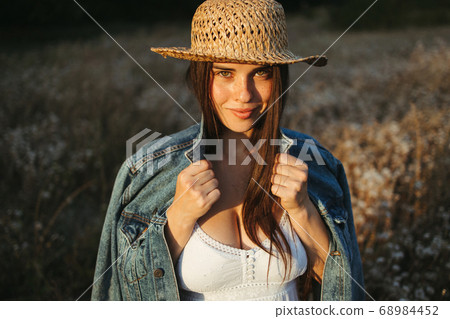 Young girl in trendy summer dress and straw hat Young girl in trendy summer dress and straw hat 68984452