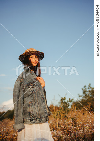 Young girl in trendy summer dress and straw hat Young girl in trendy summer dress and straw hat 68984454