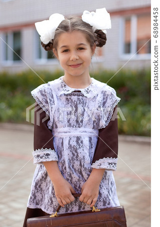 little girl on the street in the form of the USSR with a briefcase, girl in the form of September 1, Soviet uniform little girl on the street in the form of the USSR with a briefcase, girl in the form of September 1, Soviet uniform 68984458
