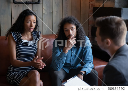 Unhappy young African American man and woman visiting psychologist 68984592