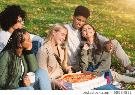 Teen friends having picnic at public park Teen friends having picnic at public park 68984851