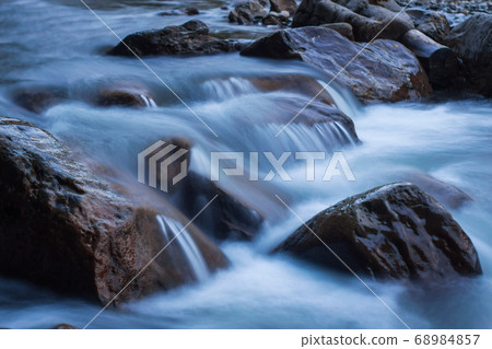 Wild nature concept. Raging mountain river running Wild nature concept. Raging mountain river running 68984857
