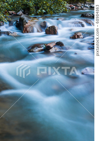 Nature scene of rough, fast flowing river hitting Nature scene of rough, fast flowing river hitting 68984863