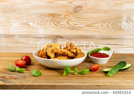 Breaded Fried Chicken Wings, Fingers and Drumstick 68985818