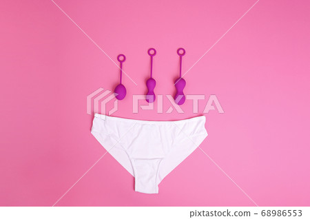 woman holds a kegel trainer. Latex vaginal vibrator for training the pelvic floor muscles with an 68986553