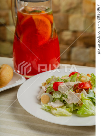 Fresh caesar salad in a white plate on the table. Fresh caesar salad in a white plate on the table. 68986967