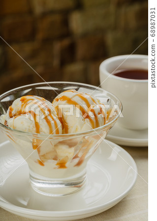 White ice cream in a glass glass with caramel. 68987031