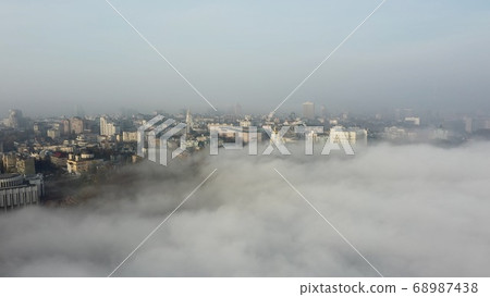 Aerial view of the city in the fog. 68987438