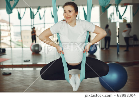 Pregnant woman doing yoga in a gym 68988304