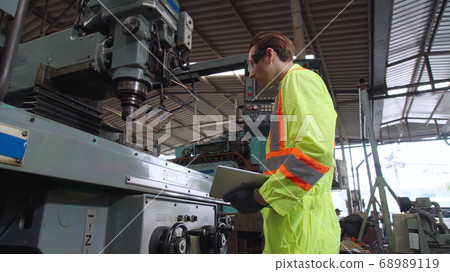 Smart factory worker using machine in factory workshop Smart factory worker using machine in factory workshop 68989119