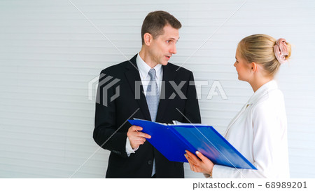 Two business people talk project strategy at office 68989201