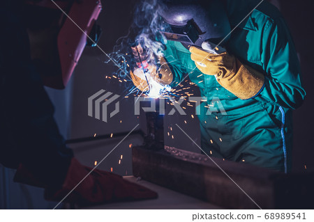 Metal welding steel works using electric arc welding machine 68989541