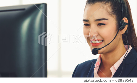 Business people wearing headset working in office 68989542