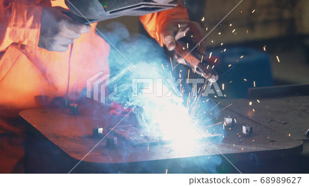Metal welder working with arc welding machine Metal welder working with arc welding machine 68989627