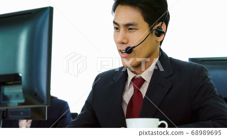 Business people wearing headset working in office 68989695