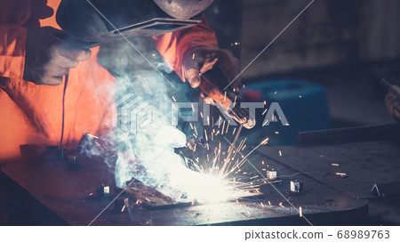 Metal welder working with arc welding machine Metal welder working with arc welding machine 68989763