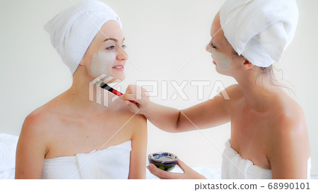 Beautiful woman having a facial treatment at spa. 68990101
