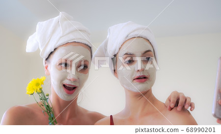 Beautiful woman having a facial treatment at spa. Beautiful woman having a facial treatment at spa. 68990201
