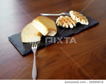 Baumkuchen and waffles on a slate plate 68990616