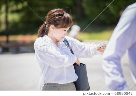 Business woman looking for something in bag Business woman looking for something in bag 68990842