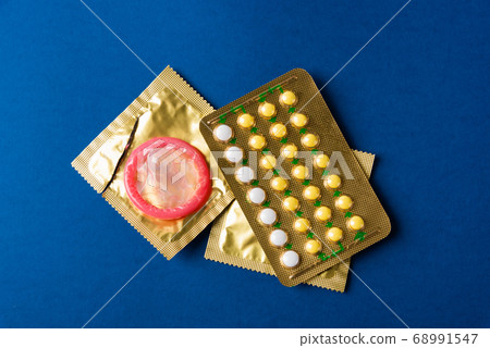 condom on wrapper pack and contraceptive pills 68991547