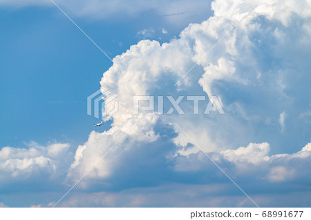 Immigration clouds and aircraft/Summer sky 68991677