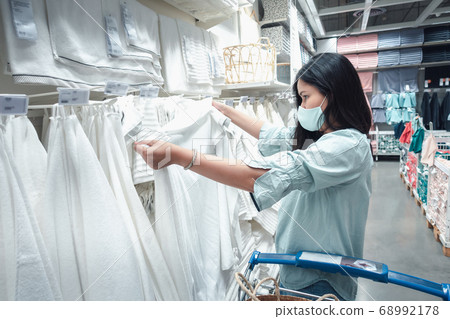 Customer Asian Woman Wearing Face Mask With Shopping Cart in Supermarket Department Store Customer Asian Woman Wearing Face Mask With Shopping Cart in Supermarket Department Store 68992178