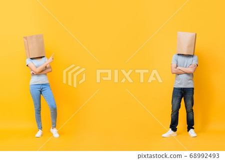 Full length portrait of faceless anonymous paper bag head couple 68992493