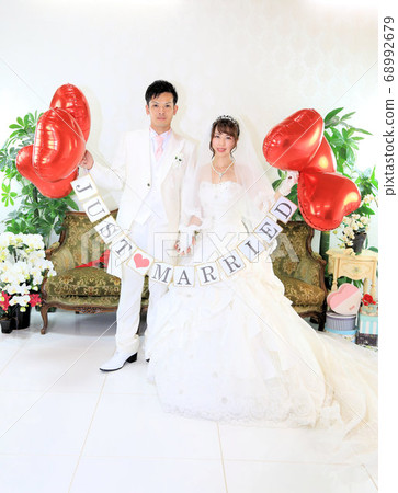 Bride and groom in a wedding dress and tuxedo 68992679