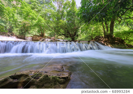 Waterfall in deep rain forest jungle (Thung Nang Khruan Waterfall) Thailand 68993284