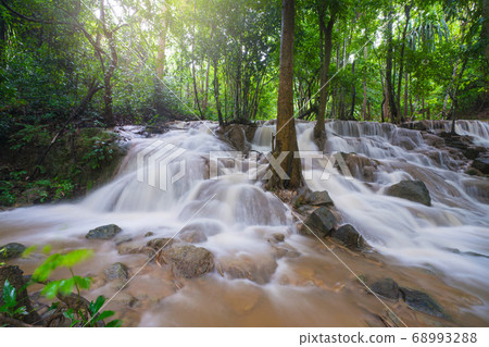 Waterfall scene at Pha Tad Waterfalls in rainforest at the Khuean Srinagarindra National Park Waterfall scene at Pha Tad Waterfalls in rainforest at the Khuean Srinagarindra National Park 68993288