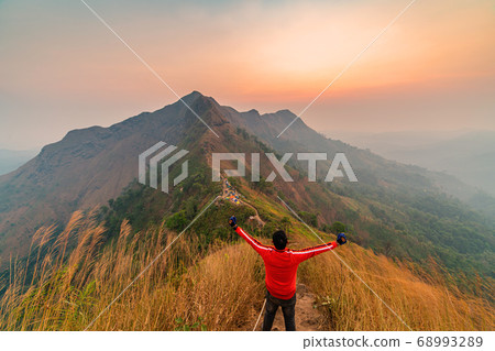 traveler man hiking enjoying in the mountains with backpack at Khao Chang Puak mountain Thailand traveler man hiking enjoying in the mountains with backpack at Khao Chang Puak mountain Thailand 68993289