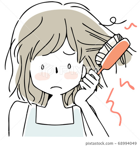 A woman stroking her hair 68994049