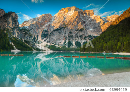 Fantastic wooden boats on the alpine lake, Dolomites, Italy 68994459