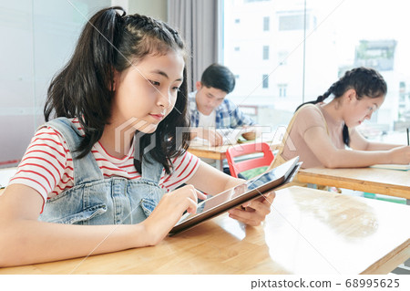 Schoolgirl reading text 68995625