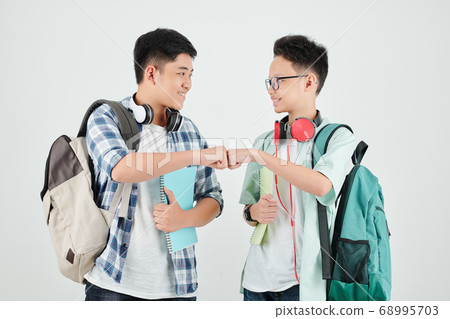 School students making fist bump 68995703