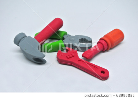 Toy carpentry tools are made of colorful soft rubber isolated on white background.  68995885