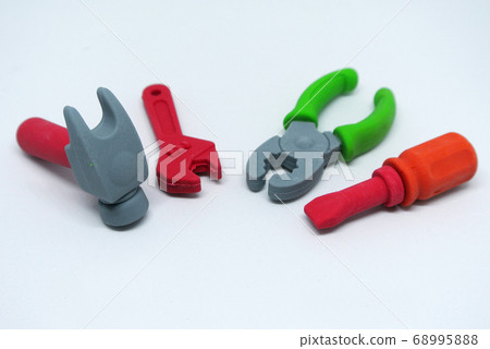 Toy carpentry tools are made of colorful soft rubber isolated on white background. Toy carpentry tools are made of colorful soft rubber isolated on white background. 68995888