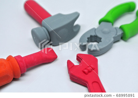Toy carpentry tools are made of colorful soft rubber isolated on white background.  68995891