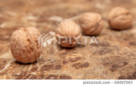 Walnuts on a marble table on the table Walnuts on a marble table on the table 68997065