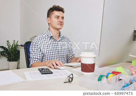 UI designer working on computer 68997473